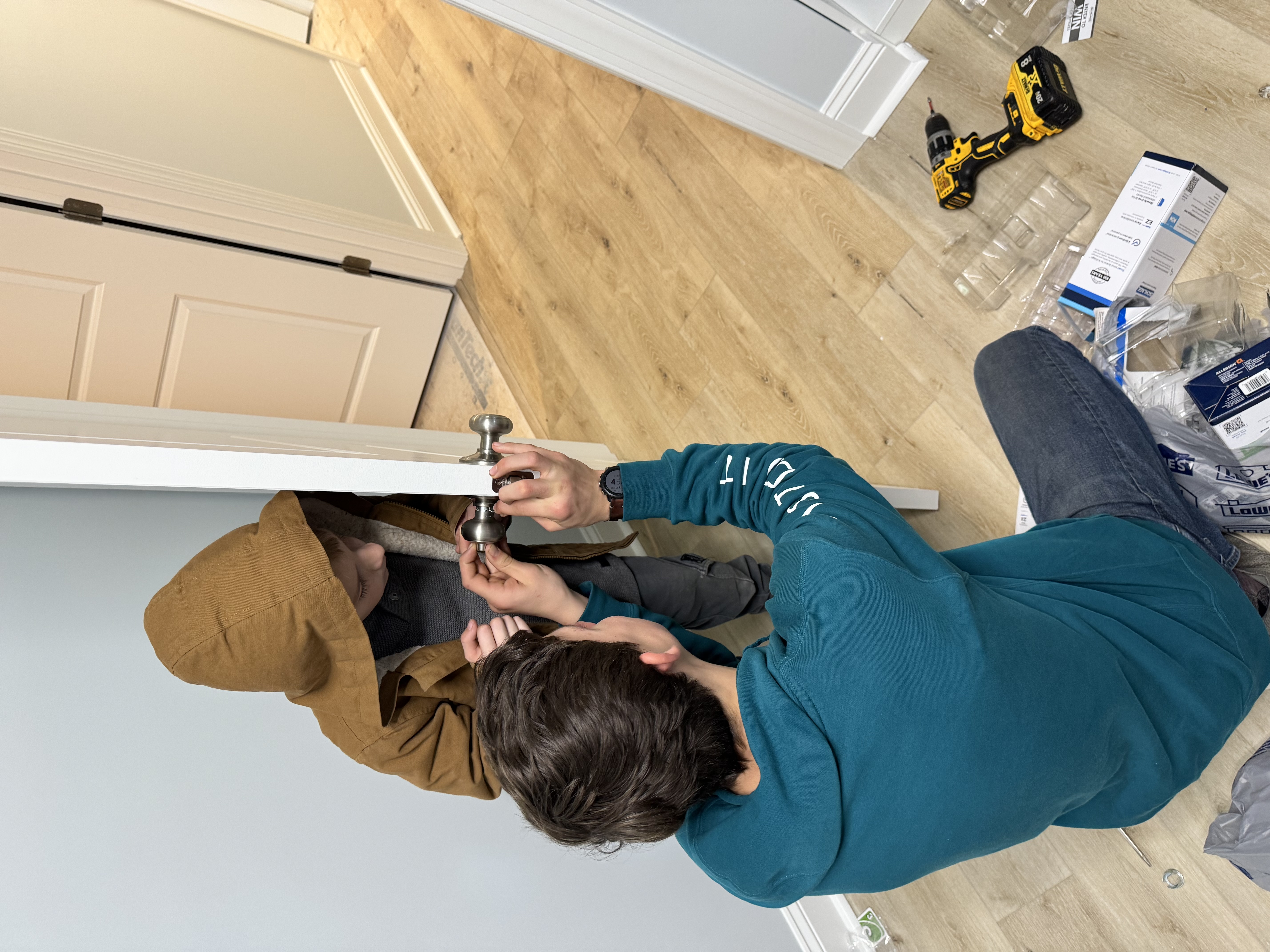 Finished hallway with warm wood-look flooring and white trim