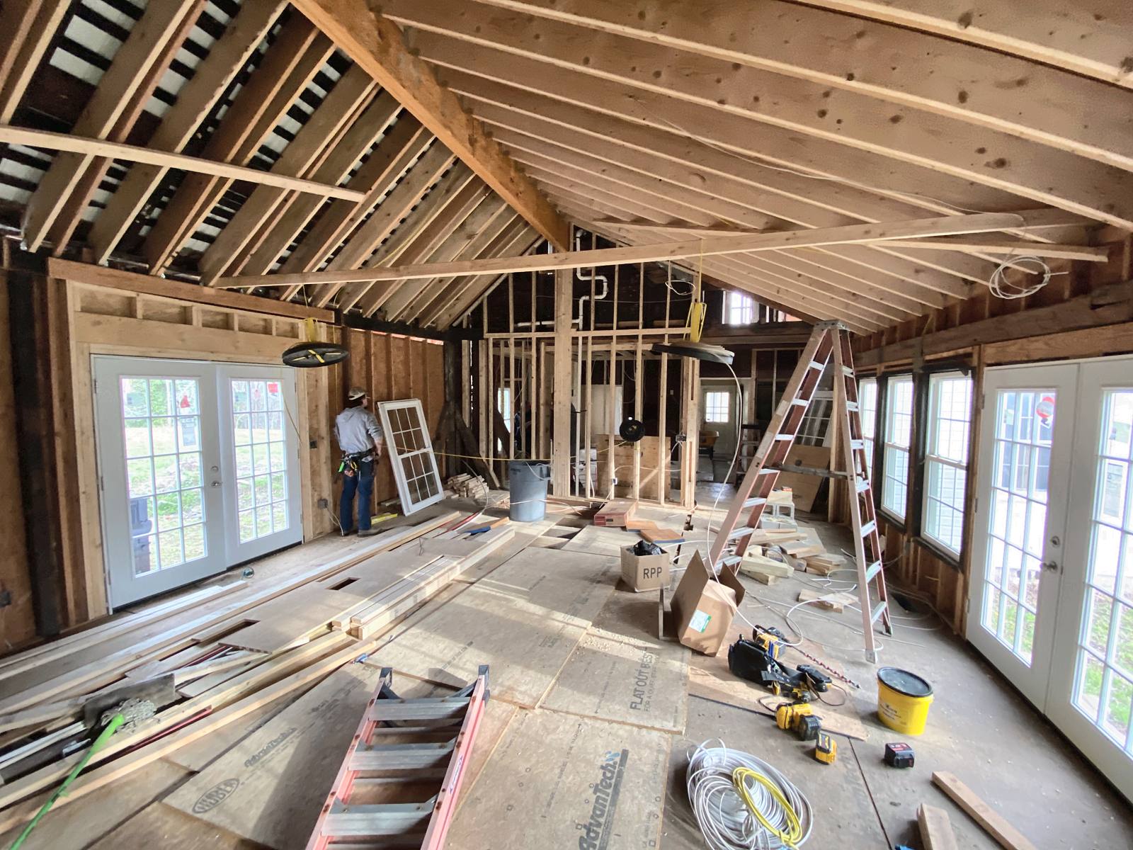 Now that we've installed a new ridge beam and sistered all the existing ceiling framing, we removed scaffolding, and the open floor plan can be realized
