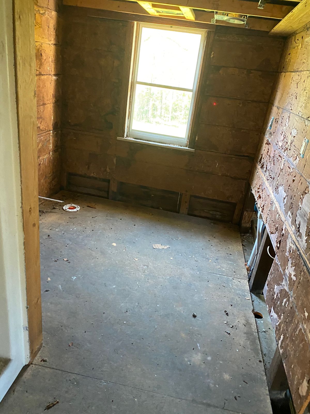 A back bedroom. The floor had dropped enough that the window trim had pulled away from the wall