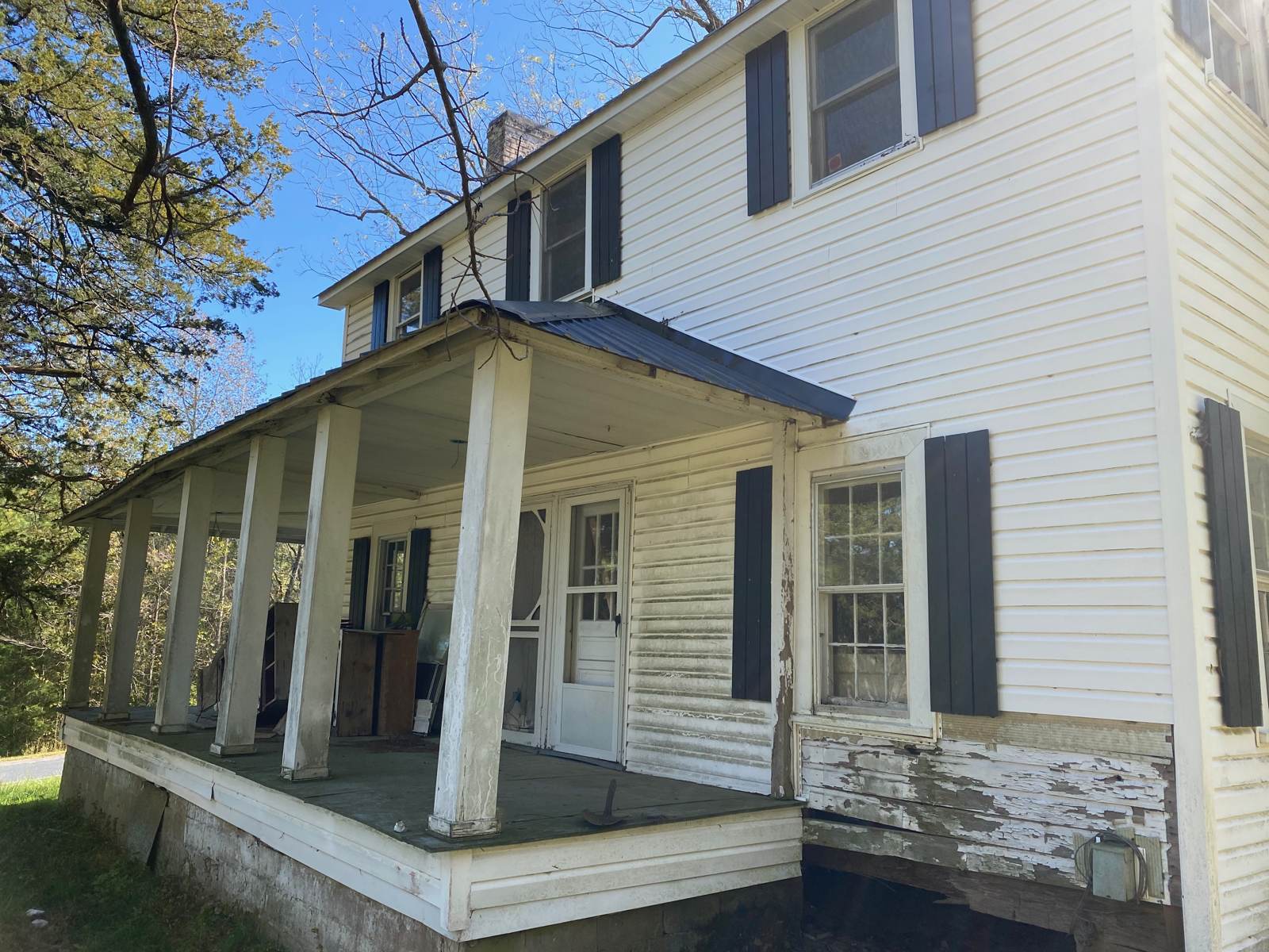 The front porch and the two-story main block. Peeling paint and a dropped porch floor were the least of it