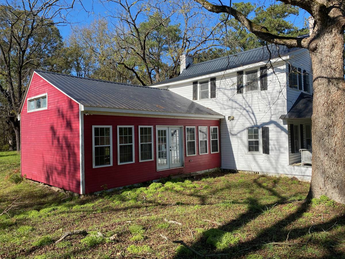 The north side: the addition in red, the main house in white, and the back corner that had settled