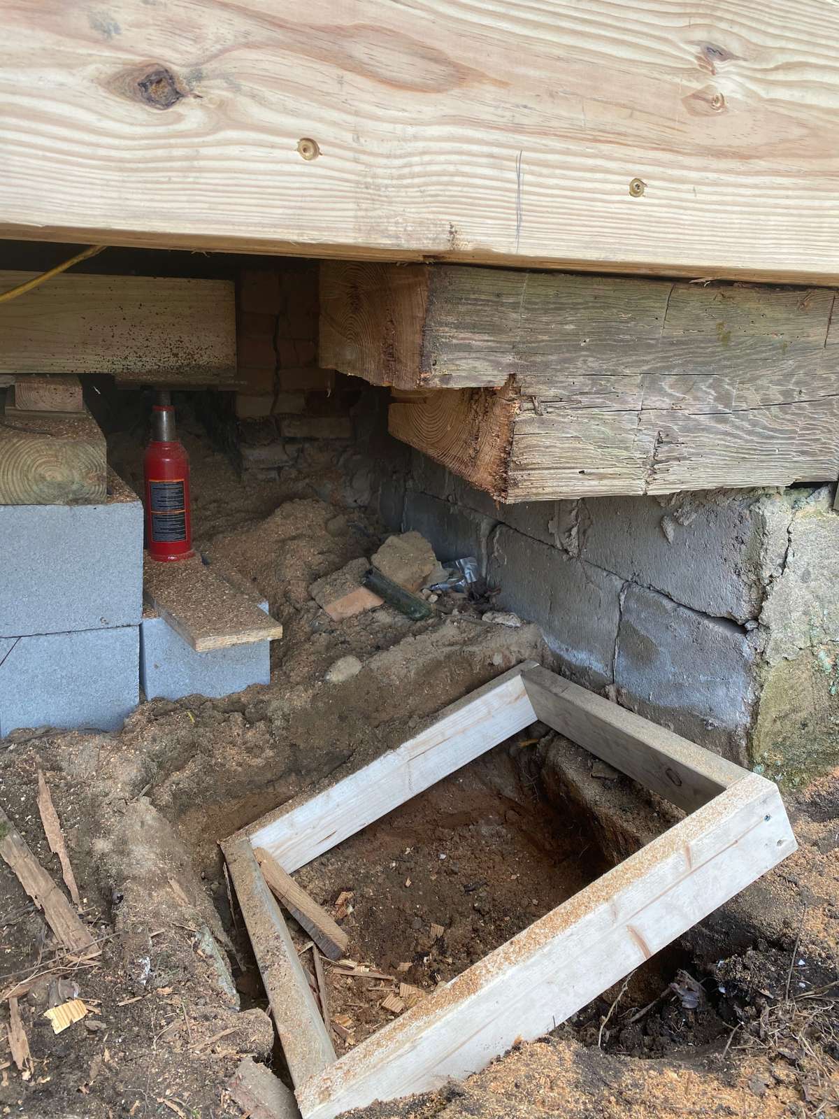 Forming a new footing for a pier under the house, where the engineer called for it