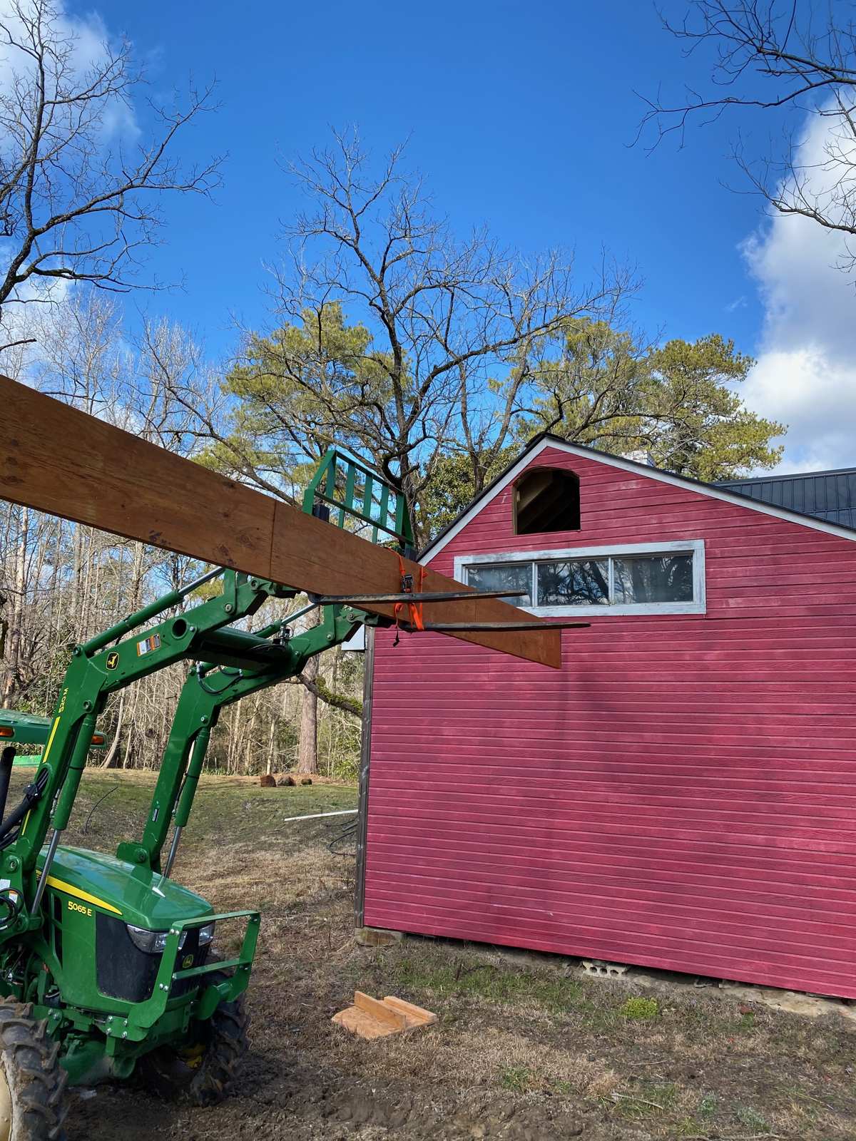 Lifting the ridge beam into the addition with the tractor
