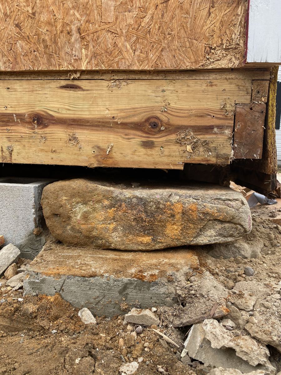 The new sill beam bearing on a rebuilt stone-and-block pier