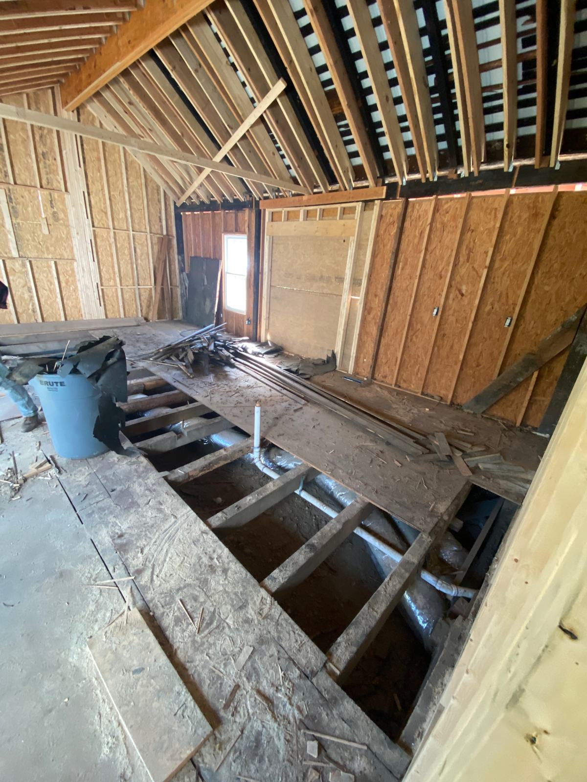 Opening up kitchen flooring to allow for plumbing and HVAC ductwork to be installed. We had to remove a lot of the existing stuff to get plastic down between th