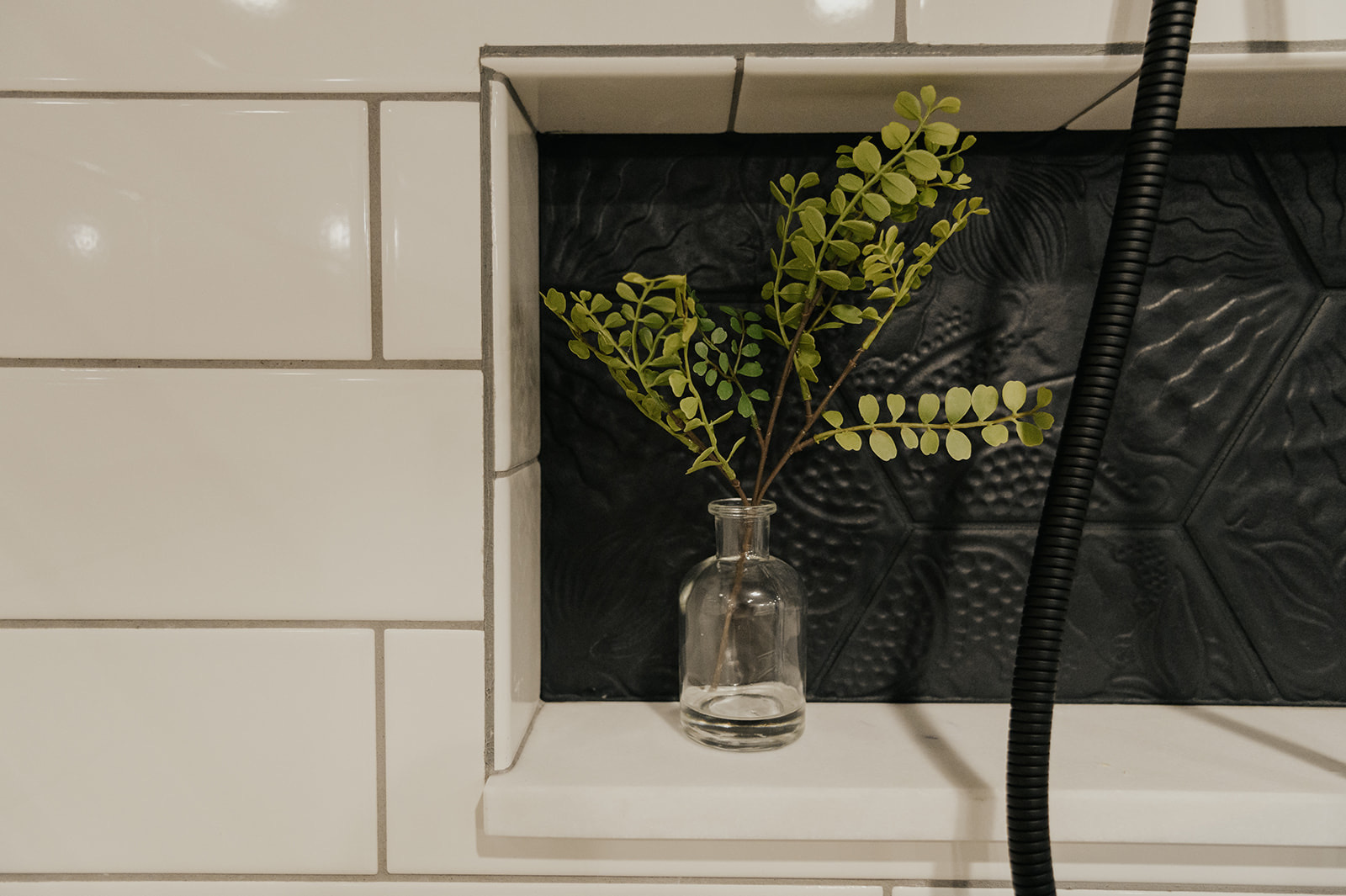 After: dark hexagonal floor tile and the preserved original window with new frosted glazing