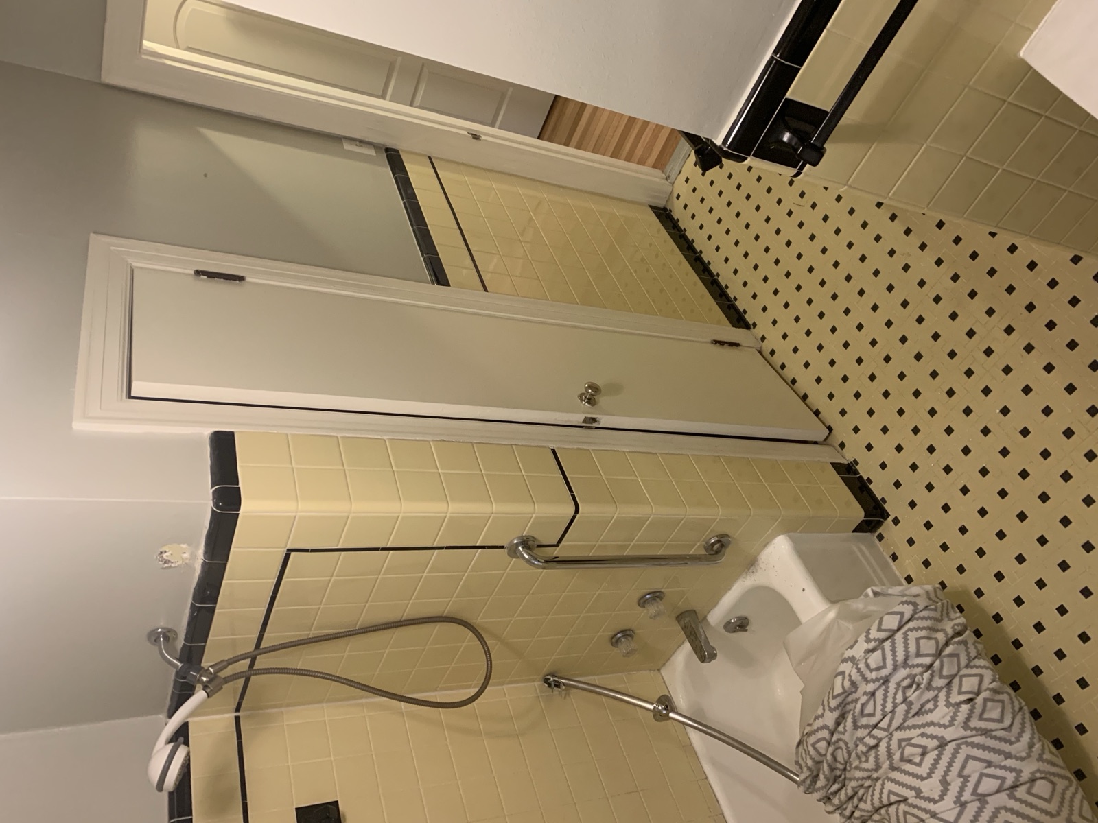 Before: linen closet door and tub area showing the cramped original layout