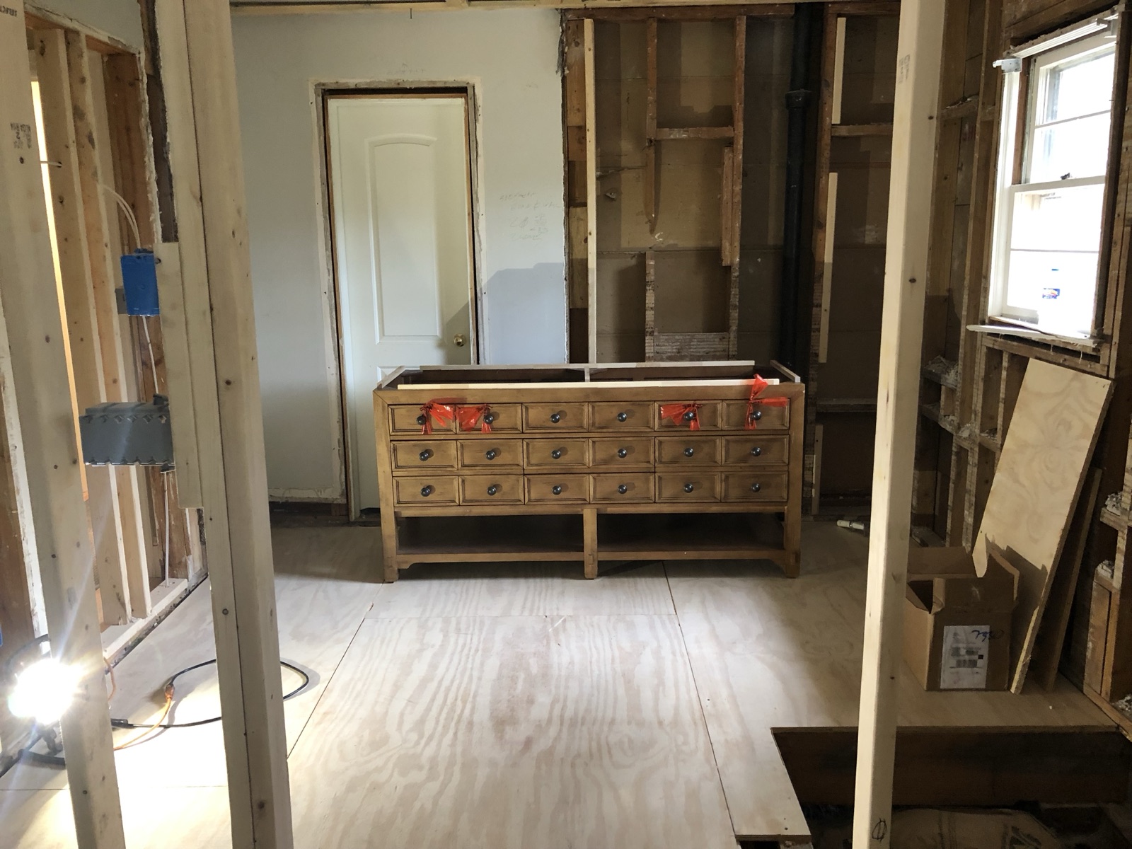 During: dark hexagonal floor tile being set over the radiant heating membrane