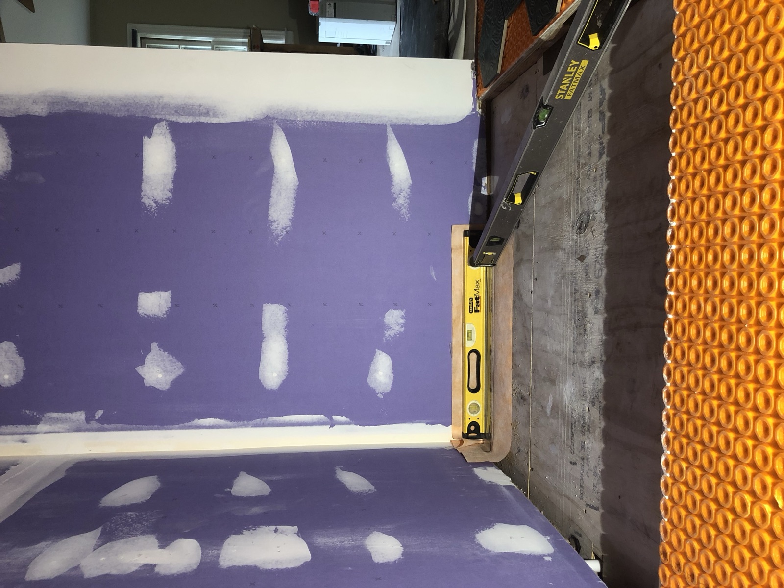 During: white subway tile installation in the zero-entry walk-in shower